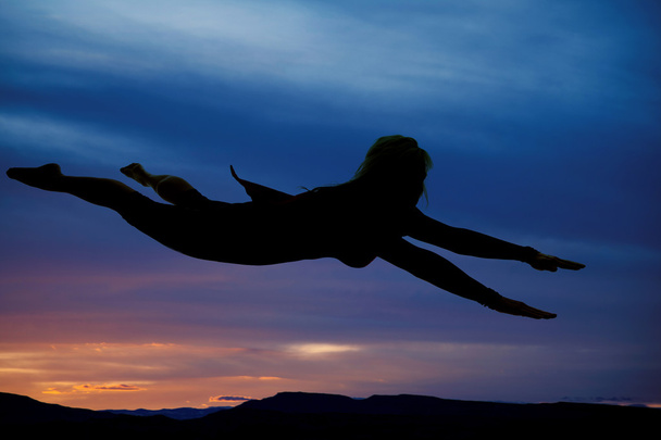 Silhouette woman flying cape on - Foto, imagen