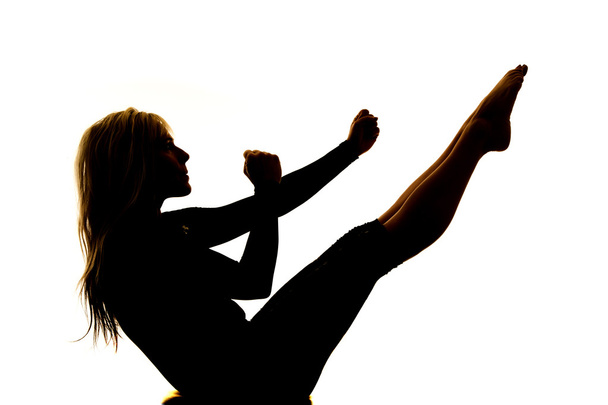 Silhouette woman doing an ab workout - Фото, изображение