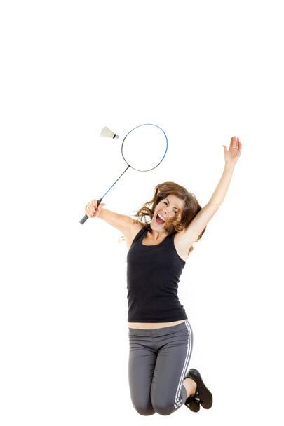 Badminton player in action holding racket to catch shuttlecock - Fotoğraf, Görsel