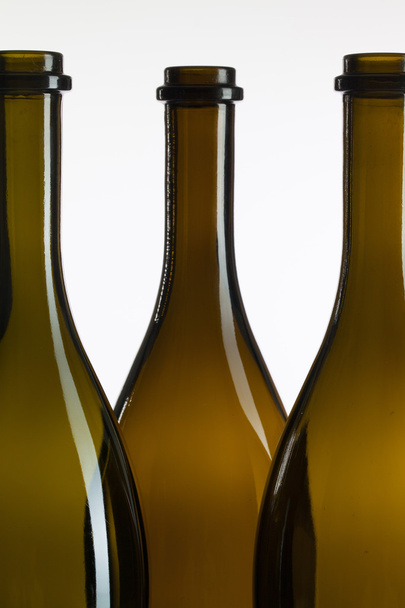 Detail of three empty wine bottles - Foto, afbeelding