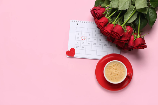 Calendar with marked date of Valentine's Day, roses and cup of latte on pink background - Photo, Image