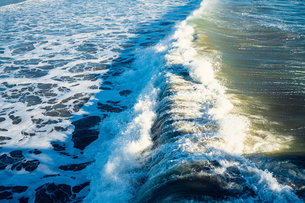 Large waves break off the Pacific shore of California. Water surface, water background, beauty in nature, dark blue, turquoise colors - Photo, Image