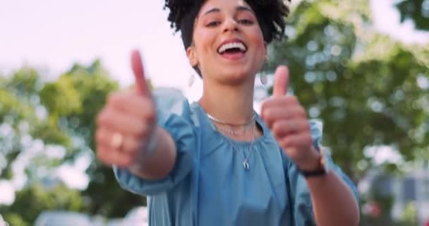 Face, black woman and thumbs up in nature, achievement and good news. African American female, girl and hands in positive action, winner and success with goal, deal and happiness for growth and smile. - Πλάνα, βίντεο