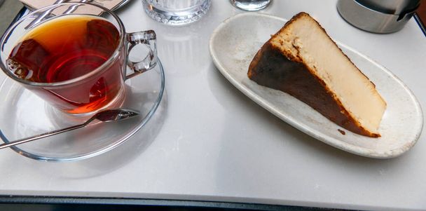 Turkish Traditional Tea and Cheesecake served in a restaurant - Foto, afbeelding