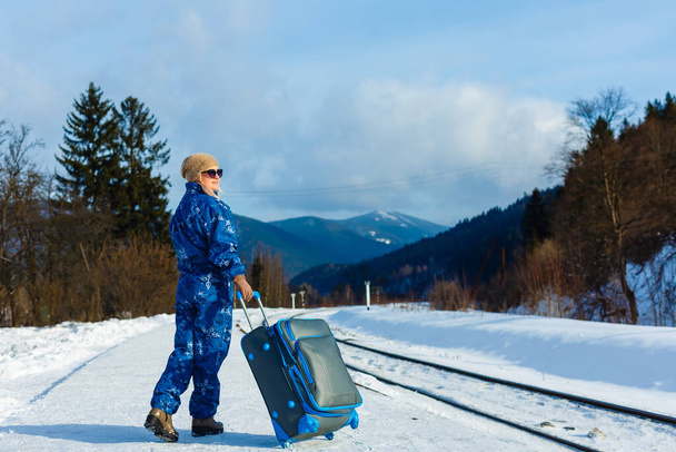 Nainen hiihtopuvuissa seisoo lähellä rautatietä - Valokuva, kuva