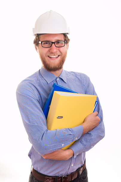 Young happy engineer in helmet holding documents - Foto, imagen