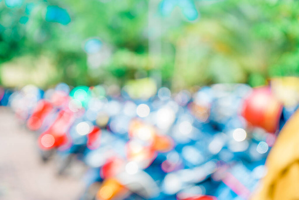 Defocused abstract background of a lot of motorcycles at the parking area. Blurred out park area background - Foto, Imagen