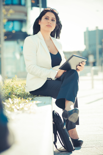 Business woman using tablet in the city - 写真・画像