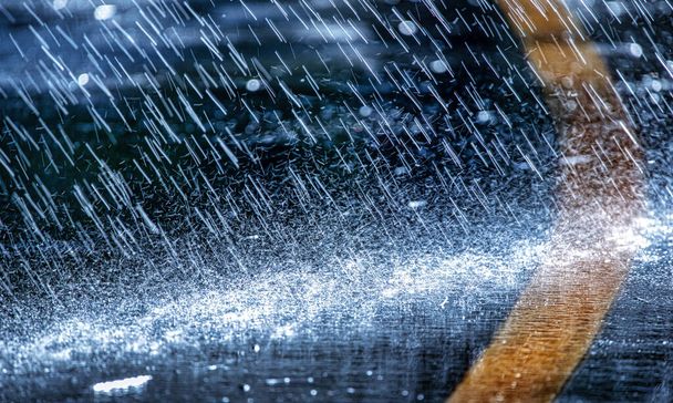 Raindrops fall on the asphalt. Deterioration of weather conditions. Precipitation, cooling. - Valokuva, kuva