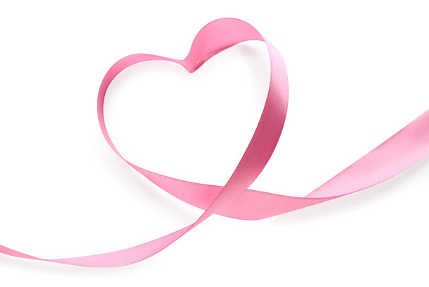 Heart made of pink ribbon on white background. Valentine's Day celebration - Zdjęcie, obraz