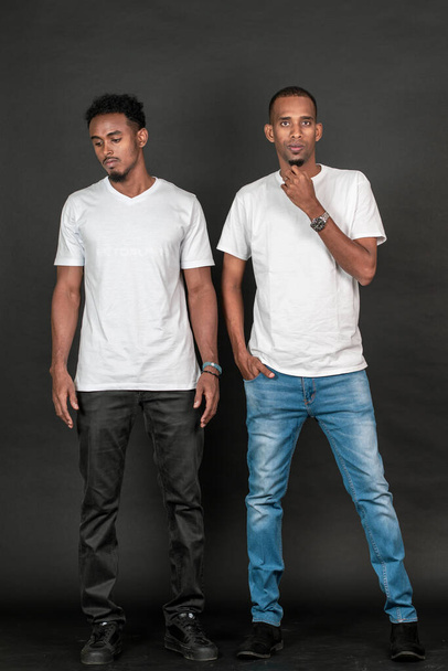Two african man with white blank shirt doing a simple pose on the white background mockup image - Foto, immagini