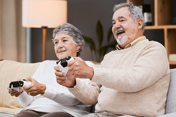 Video game, sofa and senior couple with gaming online in home for happy holiday, retirement and lifestyle together with technology. Excited, elderly and gamer people on couch on games in living room. - Foto, Imagen