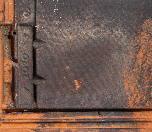 Close up terracotta roof tile with numbers imprinted and covered in black mildew stain background texture - Foto, imagen
