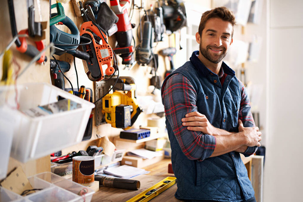 Hes prepared for any project. Portrait of a handsome young handyman standing in front of his work tools - Foto, immagini