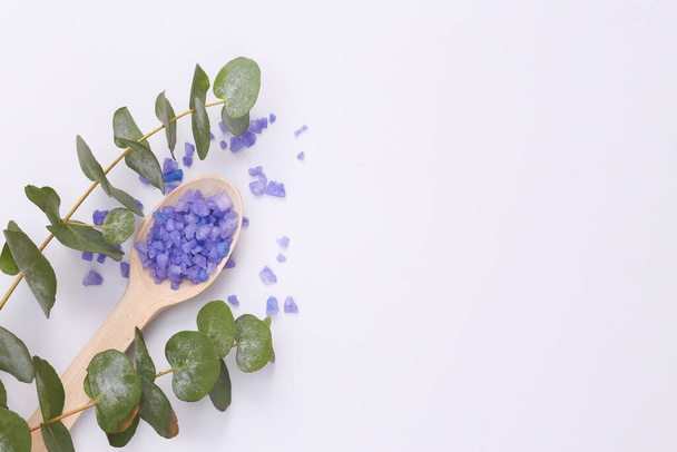 Spas, aromatherapy. Lavender bath salt with a sprig of eucalyptus on white background. Top view. Copy space - Foto, imagen