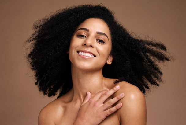Black woman, beauty portrait and happiness for skincare wellness, natural afro hair care and cosmetics dermatology in brown background studio. African model, smile and luxury self care body glow. - Photo, Image
