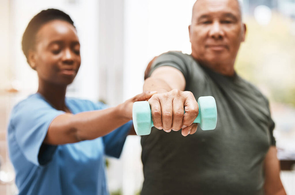 Medical, training and physiotherapy with dumbbell and old man with nurse for rehabilitation, support and retirement. Healthcare, help and physical therapy with patient and black woman in nursing home. - Foto, immagini
