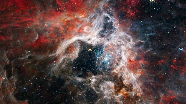 Κοσμικό Νεφέλωμα Ταραντούλας στο διάστημα. τηλεσκόπιο Τζέιμς Γουέμπ. Στοιχεία αυτής της εικόνας που παρέχονται από τη NASA. - Φωτογραφία, εικόνα