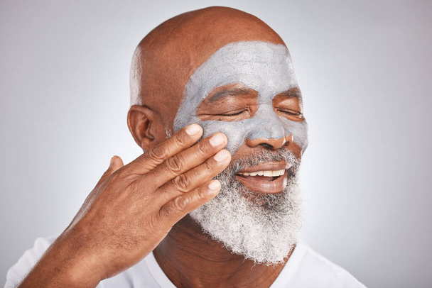 Skincare, face or senior black man with cream marketing or advertising a luxury beauty product for self care. Studio background, cosmetics or African old man with a happy smile applying facial mask. - Fotografie, Obrázek