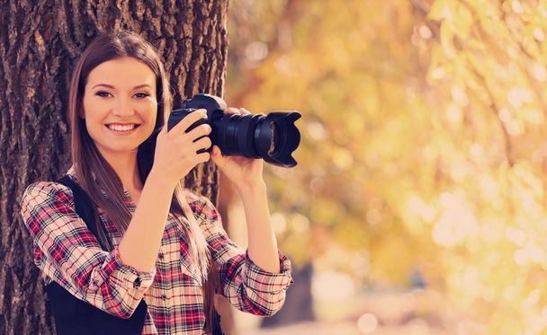 Young photographer taking photos outdoors - Valokuva, kuva