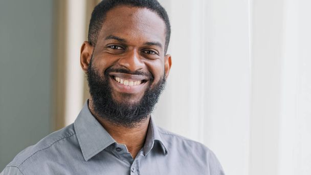 Headshot positive adult bearded African American male company manager worker leader boss CEO businessman guy man satisfied smiling in office looking at camera ethnic entrepreneur employer portrait - Foto, Imagem