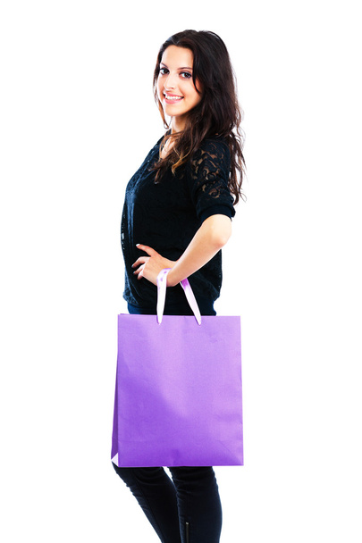Young woman carrying shopping bag - Фото, изображение