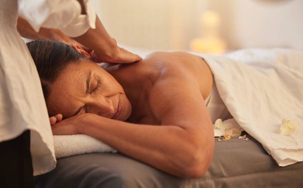 Woman at spa for massage with therapist and holistic treatment, wellness and self care with aromatherapy. Luxury service, relax and peace with body care and back massage, masseuse hands for zen. - Foto, immagini