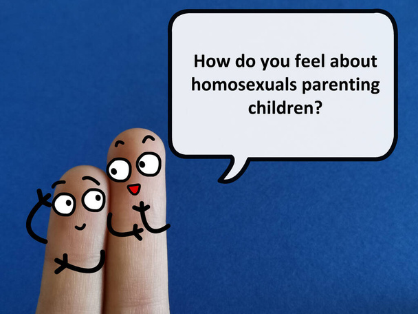 Two fingers are decorated as two person. One of them is asking another how does he feel about homosexuals parenting children. - Foto, Imagen