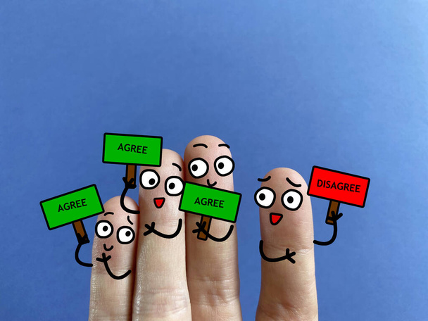 Four fingers are decorated as four person. All of them except one is agreeing with the decision. He is discriminated. - Foto, Imagem