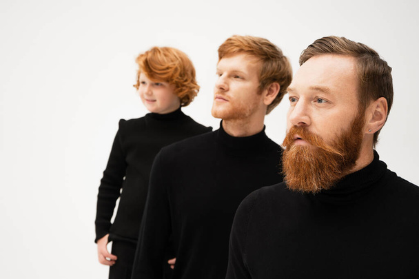 adult bearded men and redhead boy in black turtlenecks looking away isolated on grey - Foto, Imagem
