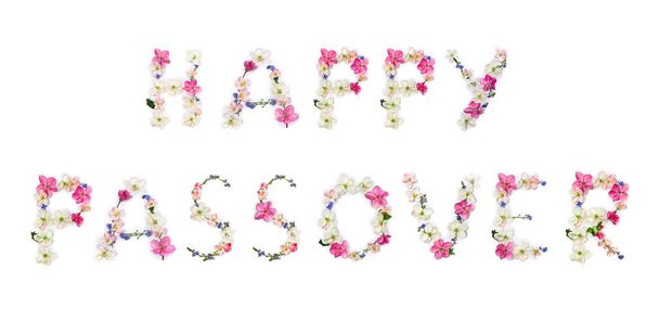 Happy Passover lettering text from of flowers apple tree and blue wildflowers forget-me-nots on white background. Top view, flat lay - Photo, Image