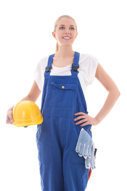 dreaming woman in blue builder uniform holding yellow helmet iso - Photo, Image
