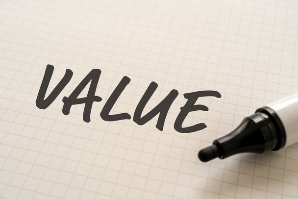 White paper written "VALUE" with a marker. - Foto, afbeelding