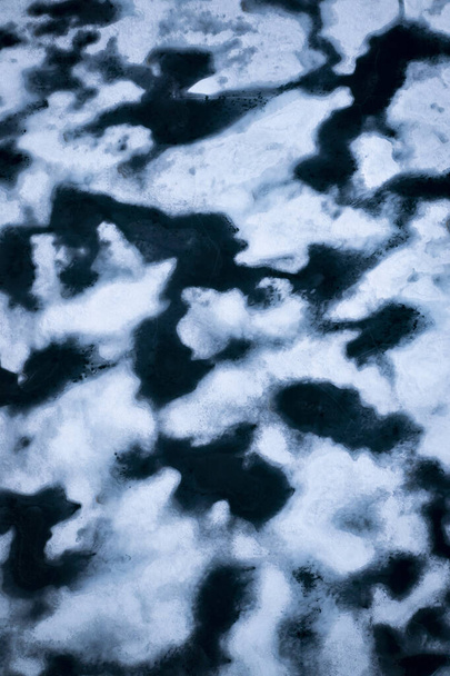 Melting ice in a lake of Hardangervidda in Norway from above - Fotó, kép
