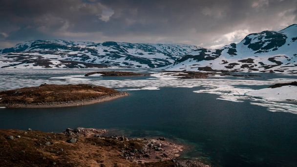 Snowy landscape of Hardangervidda national park with mountains and icy lakes in Norway, from above - Zdjęcie, obraz
