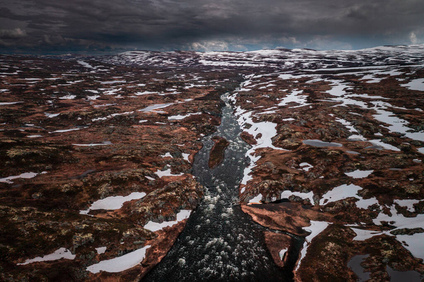 River from above with snow in the landscape of Hardangervidda National Park in Norway - Zdjęcie, obraz