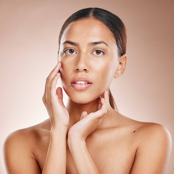 Skincare, beauty and portrait of woman with glowing skin and on studio background in Atlanta. Makeup, glamour and luxury care with hands on face and natural cosmetics for detox facial on black woman - Foto, Imagen