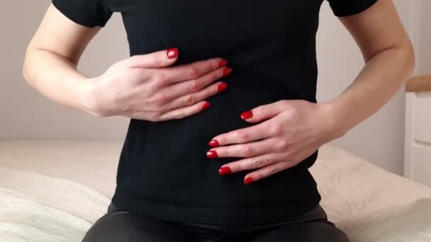 Woman with pain in stomach. She massages her belly - Felvétel, videó