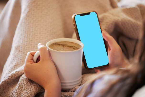 Mockup phone, coffee and woman reading screen with mobile chat, online communication and news. Brand space, app and hands of girl with a drink and cellphone for connection, media and branding. - Fotó, kép