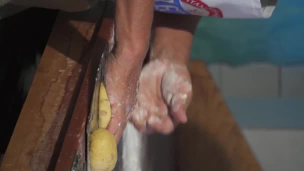 Man preparing bread dough on wooden table in bakery - Footage, Video
