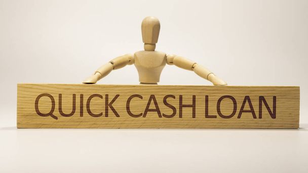 Quick cash loan was written on the wooden surface. Wooden Concept. - Photo, image