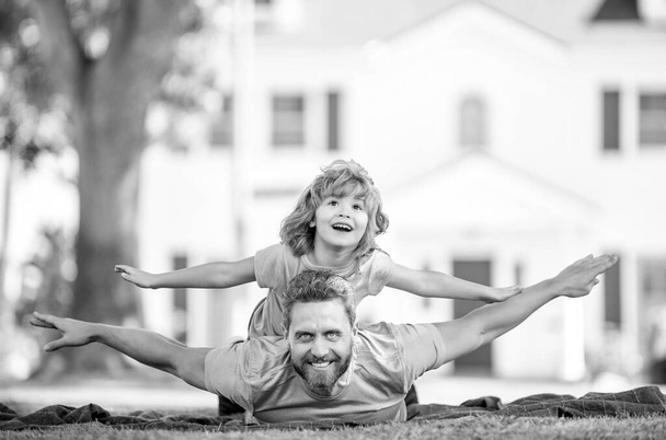 family value. childhood and parenthood. parent rest with little child boy on grass. dad with kid on summer day. parenting and fatherhood. fathers day. happy father and son having fun in park. - Photo, Image