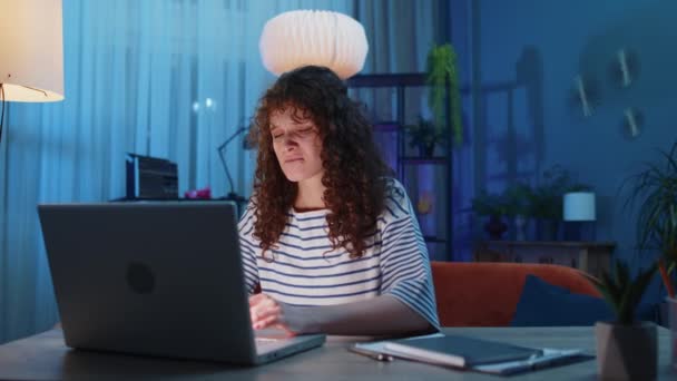 Displeased woman with curly lush hairstyle use laptop typing browsing working, loses becoming surprised sudden lottery results bad news, fortune loss fail. Adult girl at home in evening room at desk - Imágenes, Vídeo