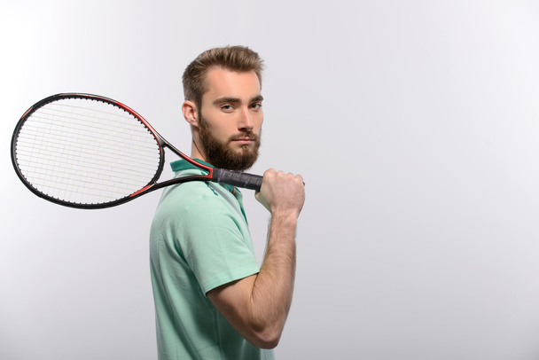 Man holding tennis racket - Zdjęcie, obraz
