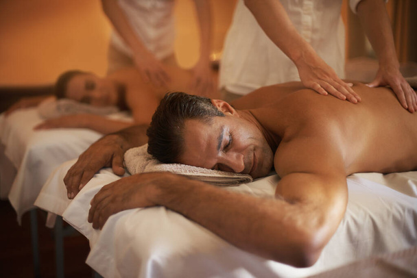 Letting the massage take them away. a mature couple enjoying a relaxing massage - Photo, Image