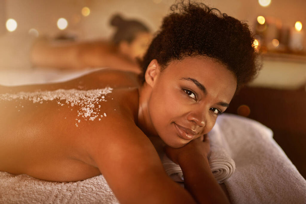 Everyday should be a spa day. a young woman enjoying a salt exfoliation treatment at a spa - Photo, Image
