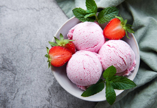 Homemade strawberry  ice cream with fresh strawberries. Sweet berry summer dessert. Concrete background - Photo, Image
