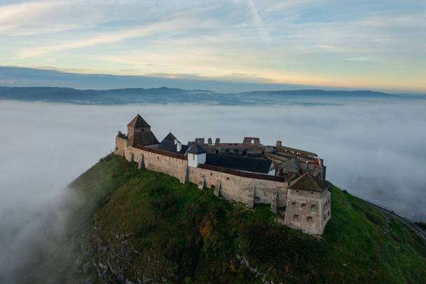 Aerial view about castle of Sumeg with foggy sunrise at the background. - Foto, Bild