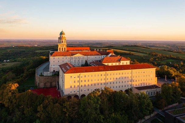 Aerial view about the Benedictine Archabbey of Pannonhalma. This is the second largest territorial abbey in the world. Hungarian name is Pannonhalmi Bences Foapatsag. Autumn sunrise landscape. - Photo, Image