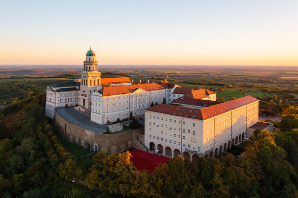 Aerial view about the Benedictine Archabbey of Pannonhalma. This is the second largest territorial abbey in the world. Hungarian name is Pannonhalmi Bences Foapatsag. Autumn sunrise landscape. - Zdjęcie, obraz